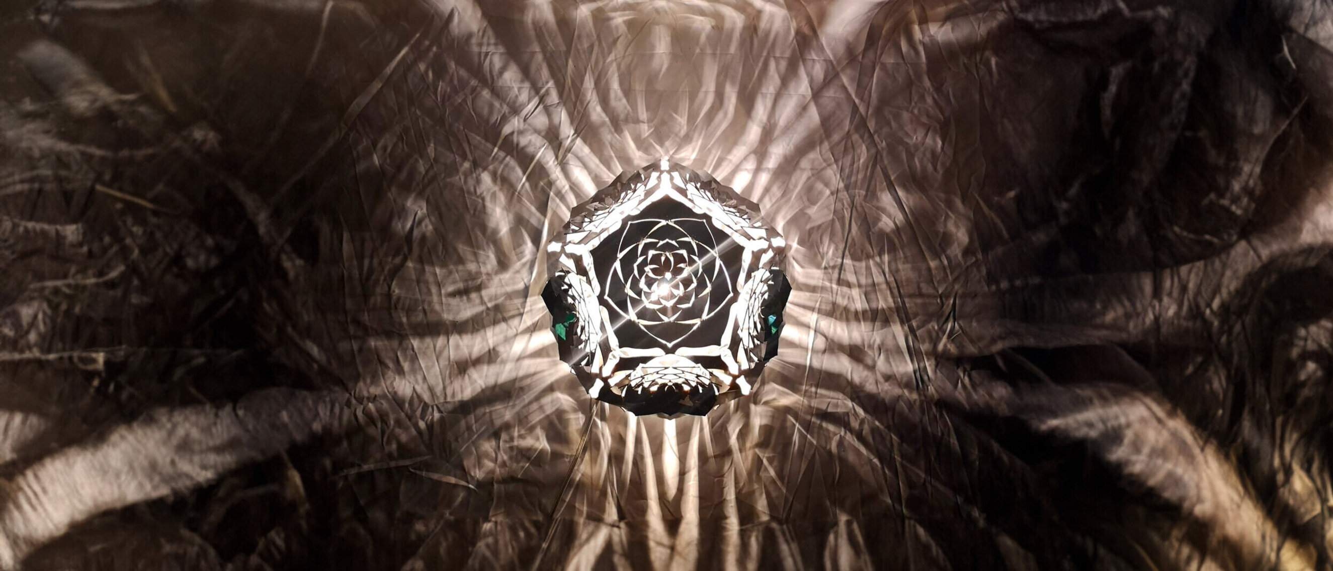 Dodecahedron Platonic Solid Sculpture: The Moon (Top View)
Top-down view of KAGE's illuminated "The Moon", casting intricate moonlit patterns in a dark ambiance.