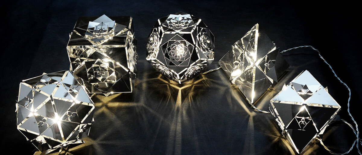 Platonic Solids Collection by KAGE: Set of Five Lamps
A collection of five lamps by KAGE, each representing a different platonic solid, glowing warmly against a dark backdrop.
