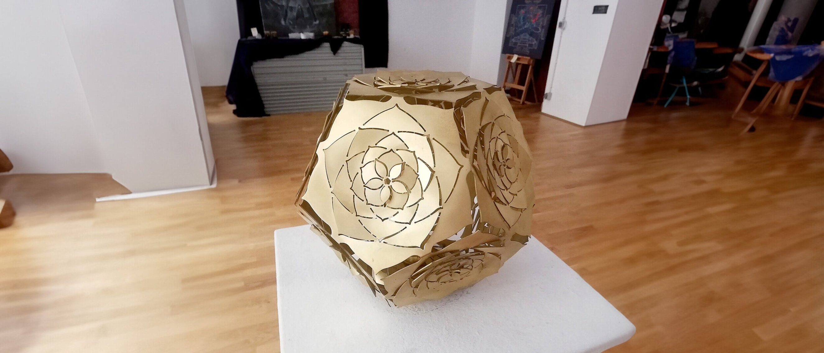 Dodecahedron Platonic Solid Sculpture: The Sun (Natural Light View)
Rotated view of KAGE's Dodecahedron Platonic Solid Sculpture "The Sun" bathed in natural light, its polished brass revealing Ether's essence through sun-ray inspired patterns.