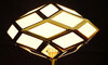 A standing lamp with a translucent matt glass lampshade showcasing delicate geometric patterns.