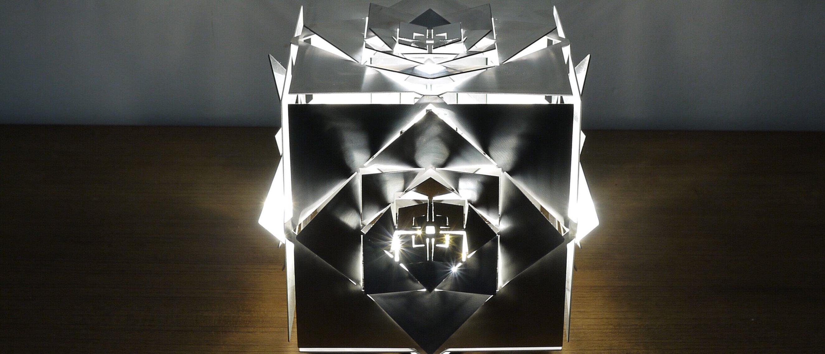 Hexaeder (Cube) Platonic Solid Lamp: Earth (Front View)
KAGE's Hexaeder (Cube) Platonic Solid Lamp in radiant stainless steel, capturing the elemental spirit of Earth.